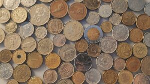 a pile of different coins sitting on top of each other